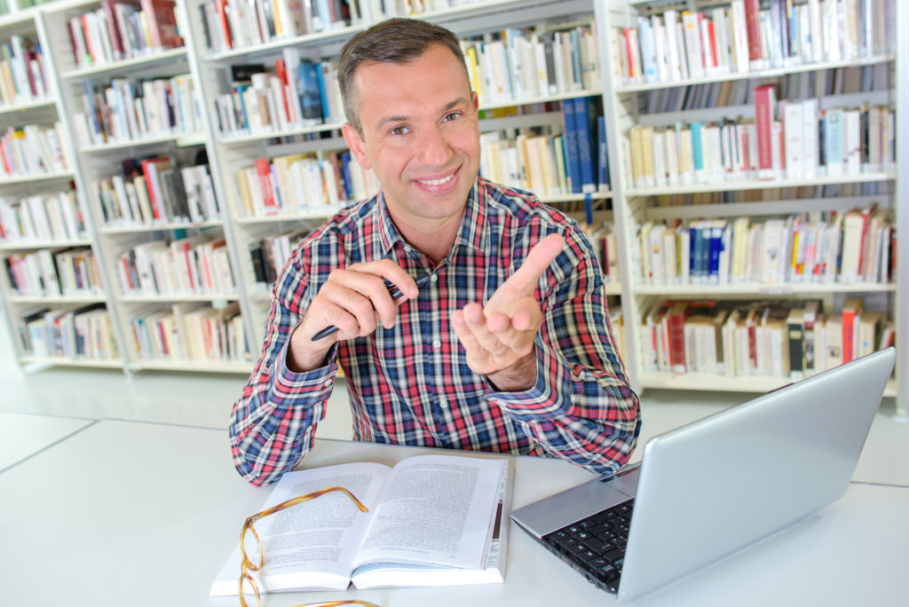Adult Student studying German in the library - Online Languages the Online Language School